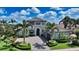 Gorgeous home featuring a paver driveway, manicured landscaping, and a three-car garage at 7665 Haddington Cv, Bradenton, FL 34202