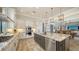Gourmet kitchen with a large island, stainless steel appliances, and custom cabinetry at 7665 Haddington Cv, Bradenton, FL 34202