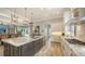Open kitchen and dining area with a center island, pendant lighting, and stainless appliances at 7665 Haddington Cv, Bradenton, FL 34202