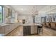 Modern kitchen featuring stainless steel appliances, granite countertops, large island, and custom cabinetry at 7665 Haddington Cv, Bradenton, FL 34202