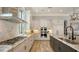 Gourmet kitchen features custom cabinets, stainless steel appliances and stone backsplash at 7665 Haddington Cv, Bradenton, FL 34202
