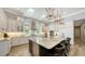 Bright kitchen featuring stainless steel appliances, granite countertops, a large island, and custom cabinetry at 7665 Haddington Cv, Bradenton, FL 34202