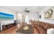 Comfortable open-concept living room with entertainment center and stairway access at 7665 Haddington Cv, Bradenton, FL 34202