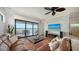 Open concept living room with sliding glass doors to a patio overlooking a lake at 7665 Haddington Cv, Bradenton, FL 34202