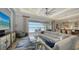 Bright living room featuring a large sofa, stylish decor, and sliding glass doors with water views and access to the pool at 7665 Haddington Cv, Bradenton, FL 34202