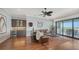 Open living room with wet bar, wood floors, bar seating and sliding glass doors at 7665 Haddington Cv, Bradenton, FL 34202