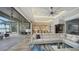 Open-concept living room boasts water views, recessed lighting, ceiling fan, and access to a patio with lounge seating at 7665 Haddington Cv, Bradenton, FL 34202