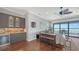 Spacious living room featuring wood floors, a wet bar, and sliding glass doors at 7665 Haddington Cv, Bradenton, FL 34202