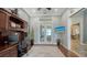 Bright office featuring a ceiling fan, a desk with a chair, and glass french doors at 7665 Haddington Cv, Bradenton, FL 34202