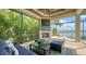 The outdoor patio features a cozy fireplace, TV, and seating, overlooking the pool and waterfront at 7665 Haddington Cv, Bradenton, FL 34202