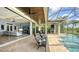 Patio view with outdoor seating, a pool, and seamless transition to the living room, offering luxurious outdoor living at 7665 Haddington Cv, Bradenton, FL 34202