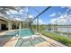 Gorgeous pool area with lake view, featuring modern design elements and landscaping at 7665 Haddington Cv, Bradenton, FL 34202