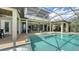 Covered patio with a pool and spa, offering an ideal setting for relaxation and entertainment with seamless indoor-outdoor flow at 7665 Haddington Cv, Bradenton, FL 34202