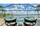 Stunning outdoor pool area with waterfront views and ample seating for relaxing and entertaining at 7665 Haddington Cv, Bradenton, FL 34202