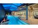 Spacious screened-in patio with a pool, spa, outdoor dining, and lounge areas, ideal for entertaining and relaxation at 7665 Haddington Cv, Lakewood Ranch, FL 34202