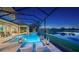 Enclosed pool area with a spa, fire features, and lounge chairs offering a relaxing and private space to enjoy the lake view at 7665 Haddington Cv, Lakewood Ranch, FL 34202