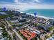 An aerial shot showcases Lido Key Beach with surrounding town, buildings, and greenery at 800 S Blvd Of The Presidents # 16, Sarasota, FL 34236