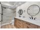 Modern bathroom with double vanity, walk-in shower, and updated fixtures at 800 S Blvd Of The Presidents # 16, Sarasota, FL 34236