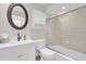 This bathroom features a bath tub, an ornate framed mirror, and a floating cabinet at 800 S Blvd Of The Presidents # 16, Sarasota, FL 34236