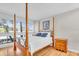 Well-lit bedroom with four poster bed, wood floors, and sunlit windows at 800 S Blvd Of The Presidents # 16, Sarasota, FL 34236
