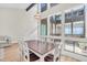 Bright dining room with views through large windows, creating an open and airy atmosphere for Gathering meals at 800 S Blvd Of The Presidents # 16, Sarasota, FL 34236