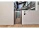 Private entrance to a condo unit featuring a gated doorway, providing security and charm within the building at 800 S Blvd Of The Presidents # 16, Sarasota, FL 34236
