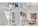 Bright foyer of a condo, with expansive windows and a dining area showcasing modern, open-concept living at 800 S Blvd Of The Presidents # 16, Sarasota, FL 34236