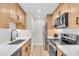 Modern kitchen boasts stainless steel appliances, light wood cabinets, and subway tile backsplash at 800 S Blvd Of The Presidents # 16, Sarasota, FL 34236