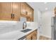 Bright kitchen featuring quartz countertops, stainless steel sink, and modern cabinetry at 800 S Blvd Of The Presidents # 16, Sarasota, FL 34236