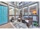 Charming condo patio with a seating area and views through large windows, perfect for relaxation at 800 S Blvd Of The Presidents # 16, Sarasota, FL 34236