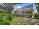 Serene backyard with a screened pool and lush landscaping, perfect for relaxation at 8183 Nice Way, Sarasota, FL 34238