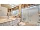 Bright bathroom with a shower over bath, decorated with towels and candles at 8183 Nice Way, Sarasota, FL 34238