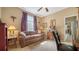 Comfortable bedroom featuring a patterned sofa and a sunny window at 8183 Nice Way, Sarasota, FL 34238