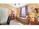 A cozy bedroom with a patterned sofa and a sunny window perfect for relaxing at 8183 Nice Way, Sarasota, FL 34238
