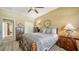 Bedroom with a queen bed, side table, window with natural light, closet and dark wood accents at 8183 Nice Way, Sarasota, FL 34238