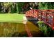 Picturesque community bridge with a bird perched on the railing against a backdrop of lush greenery and tranquil water at 8183 Nice Way, Sarasota, FL 34238