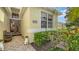 Inviting entryway with beautiful landscaping, a double door entry and tiled walkway at 8183 Nice Way, Sarasota, FL 34238