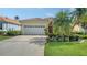 Charming home with a well-manicured lawn, mature trees, and an attached garage at 8183 Nice Way, Sarasota, FL 34238