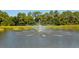 A scenic community fountain adds a touch of elegance to this tranquil waterfront setting at 8183 Nice Way, Sarasota, FL 34238