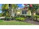 Beautiful front yard features mature landscaping and a well-maintained lawn at 8183 Nice Way, Sarasota, FL 34238