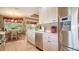 Bright kitchen features stainless steel appliances, white cabinetry, and a breakfast nook with large windows at 8183 Nice Way, Sarasota, FL 34238