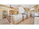 Well-lit kitchen with white cabinets and modern appliances, connected to dining and living spaces at 8183 Nice Way, Sarasota, FL 34238