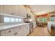 Bright and functional kitchen with white cabinetry, modern appliances and breakfast nook access at 8183 Nice Way, Sarasota, FL 34238