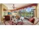 Spacious lanai with screened enclosure offering scenic outdoor views and comfortable lounging areas at 8183 Nice Way, Sarasota, FL 34238