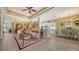Open-concept living area with elegant furnishings and decor, flowing into dining and kitchen spaces at 8183 Nice Way, Sarasota, FL 34238
