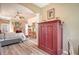 Bright main bedroom features an armoire, wood floors, tray ceilings, and large windows offering natural light at 8183 Nice Way, Sarasota, FL 34238