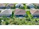 Aerial view showcasing a home in a neighborhood with well-maintained lawns and landscaping at 8668 Sundance Loop, Sarasota, FL 34238