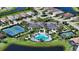 Aerial view of a community clubhouse with a pool and tennis courts, near ponds and homes at 8668 Sundance Loop, Sarasota, FL 34238