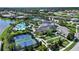 An aerial view of resort-style amenities including tennis courts, pool, and clubhouse at 8668 Sundance Loop, Sarasota, FL 34238