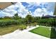 Manicured backyard featuring a putting green and serene landscaping at 8668 Sundance Loop, Sarasota, FL 34238